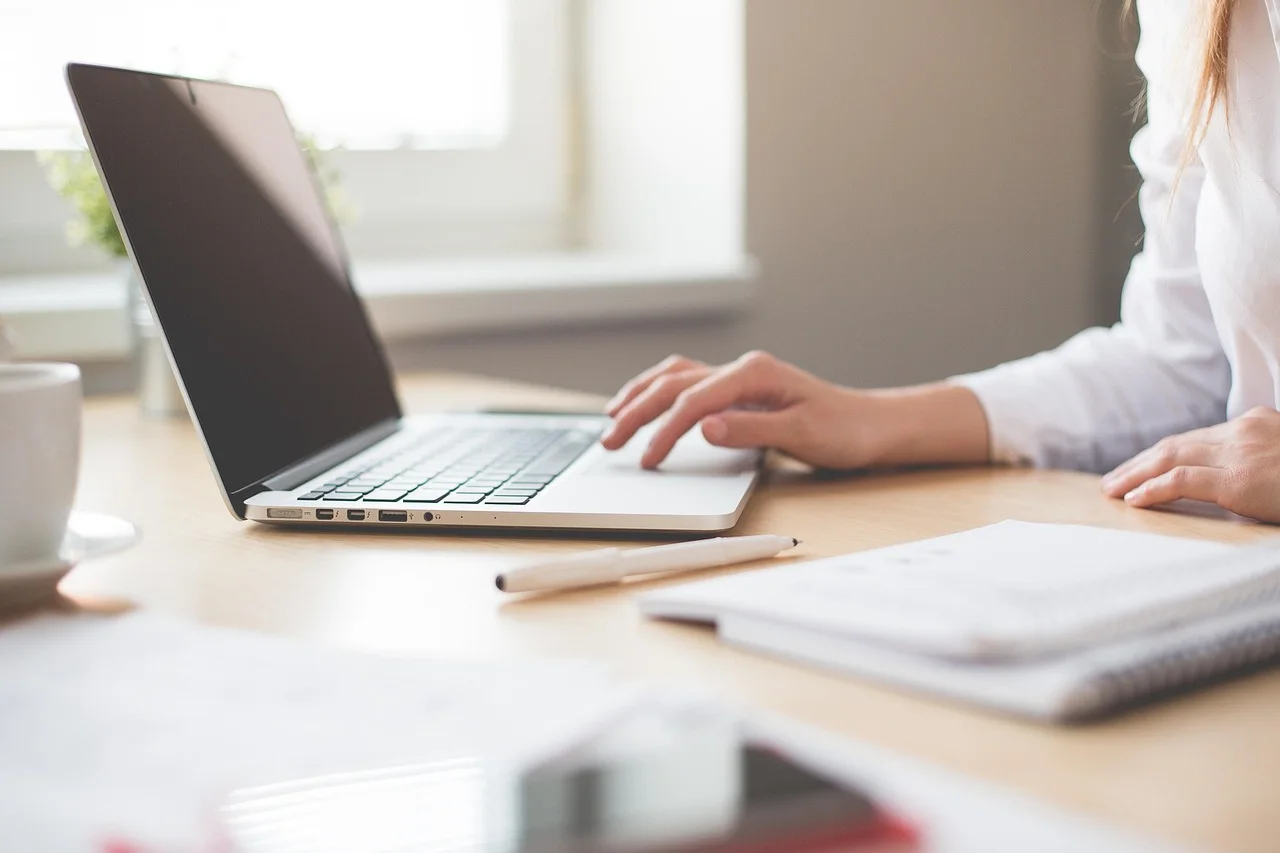 A professional working with business documents and digital tools